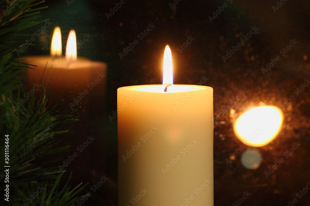 Romantic candle flame reflected in the glass, the Christmas mood Romantic candle flame reflected in the glass, the Christmas mood