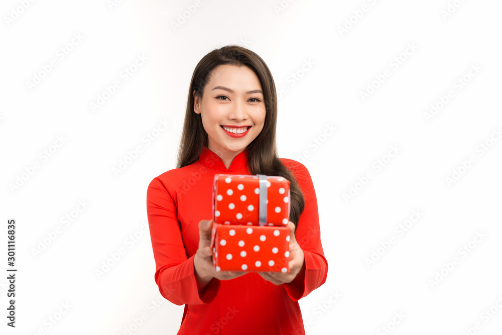 Photo of asian curious woman in traditional ao dai rejoicing new year gift box. Photo of asian curious woman in traditional ao dai rejoicing new year gift box.