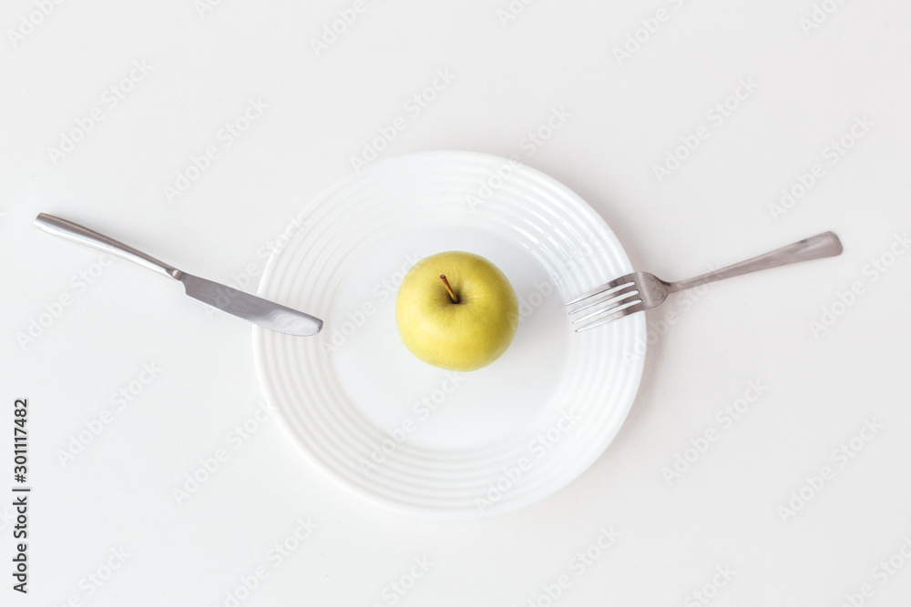Be on Diet. Apple on plate isolated on kitchen table top view close-up Be on Diet. Apple on plate isolated on kitchen table top view close-up