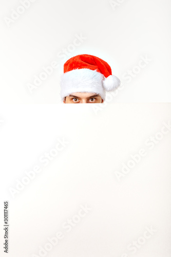 Santa man in christmas red hat for new year holiday with white paper sheet isolated on white background, copy space