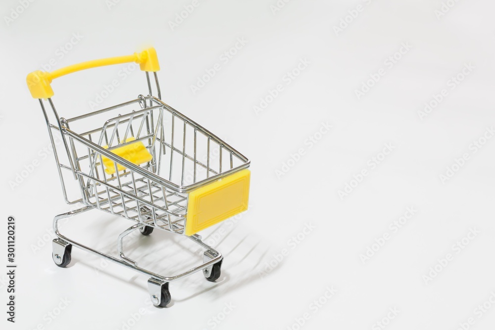 Empty yellow shopping cart isolated on white background