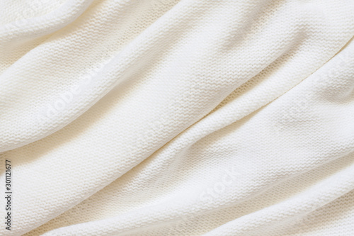 Fotografie Knitted fabric background, purl stitch pattern, soft white woolen clothes