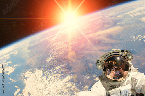 Astronaut and sunrise. The elements of this image furnished by NASA.