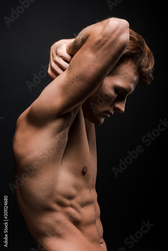 handsome sexy man posing isolated on black