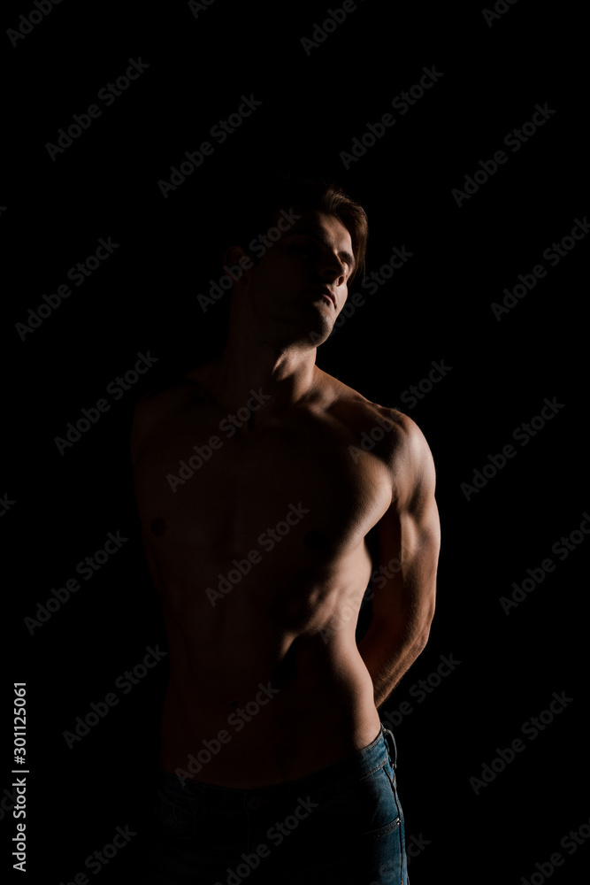 shirtless sensual man posing isolated on black