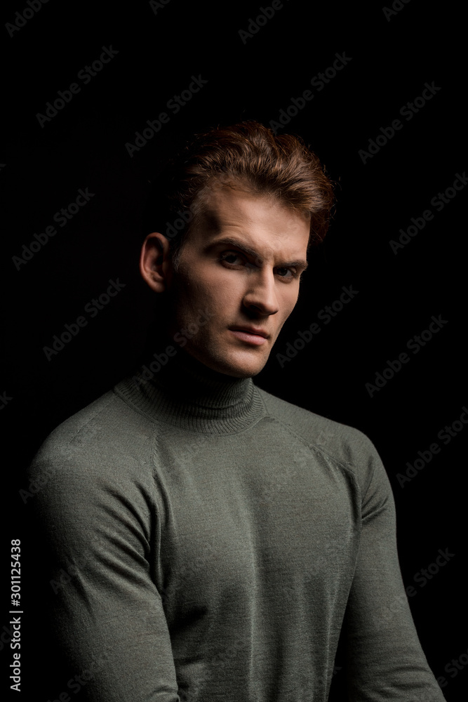 handsome sexy man posing isolated on black