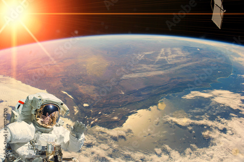 Astronaut and sunrise. The elements of this image furnished by NASA. © wowinside
