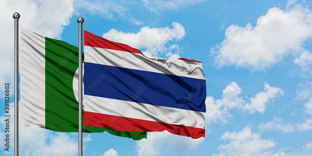 Pakistan and Thailand flag waving in the wind against white cloudy blue sky together. Diplomacy concept, international relations.