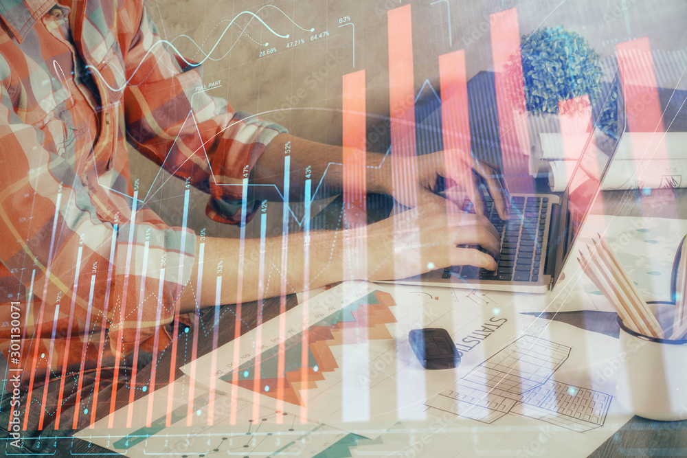 Double exposure of stock graph with businessman typing on computer in office on background. Concept of hard work. Double exposure of stock graph with businessman typing on computer in office on background. Concept of hard work.