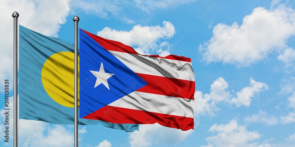 Palau and Puerto Rico flag waving in the wind against white cloudy blue sky together. Diplomacy concept, international relations.