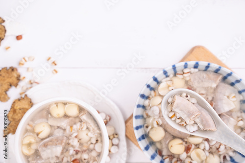 Tasty Four Tonics Herb Flavor Soup,Taiwanese traditional food with herbs,pork intestines on white wooden table,close up,flat lay,top view