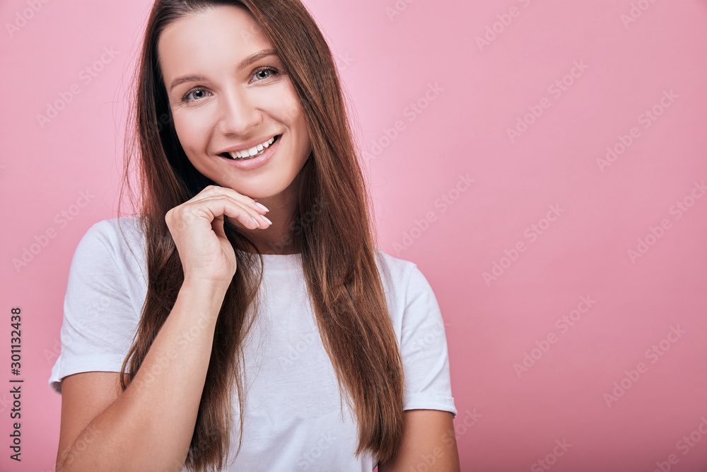 Cool attractive woman put her hand under her head and smiles sweetly. Cool attractive woman put her hand under her head and smiles sweetly.