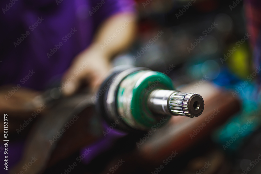 Fototapeta premium ATV constant-velocity CV joint repair in old garage