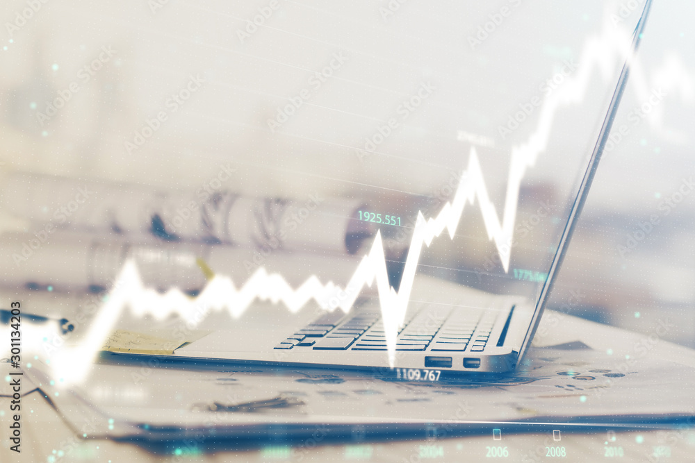 Forex graph hologram on table with computer background. Multi exposure. Concept of financial markets. Forex graph hologram on table with computer background. Multi exposure. Concept of financial markets.