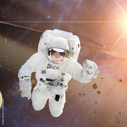 Astronaut flies in space. The elements of this image furnished by NASA.