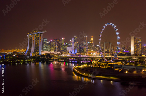 Singapore Flyer Giant Ferris Wheel and Marina Bay Sands with City Skyline illuminated at night