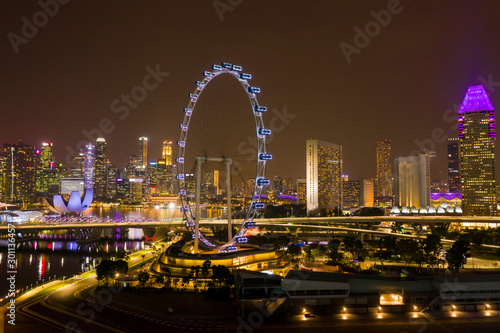 Photography Aerial view of Singapore Flyer Giant Ferris Wheel and Helix Bridge with City Sky