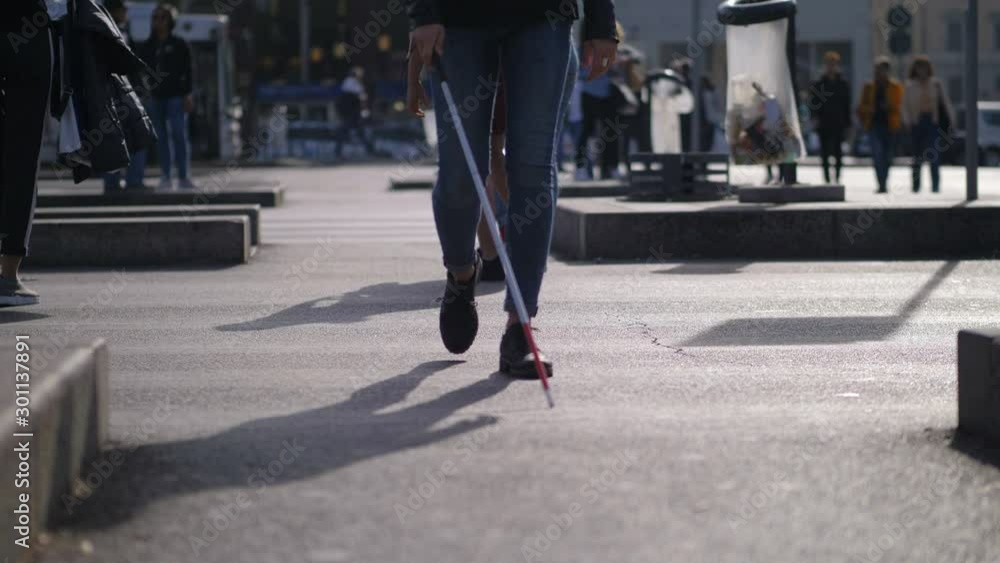 blind Young woman walking in the street with stick.Indipendence,autonomy,blind blind Young woman walking in the street with stick.Indipendence,autonomy,blind