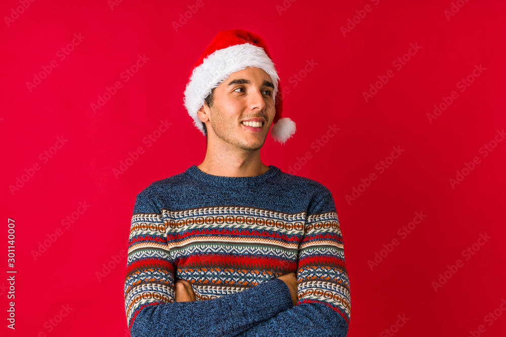 Young man on christmas day raising fist, feeling happy and successful. Victory concept. Young man on christmas day raising fist, feeling happy and successful. Victory concept.