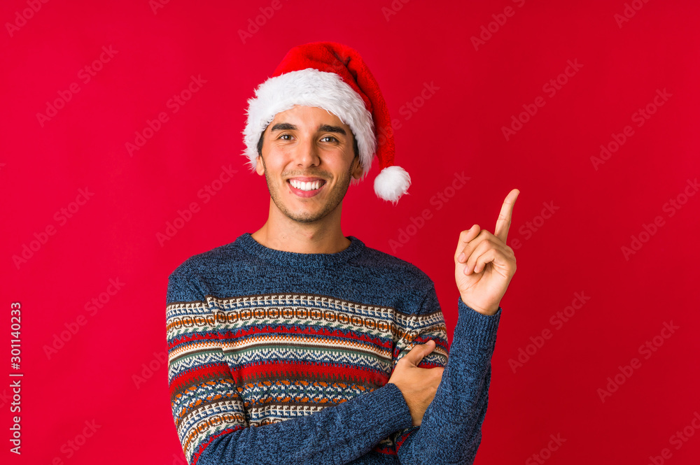 Young man on christmas day holding something with palms, offering to camera. Young man on christmas day holding something with palms, offering to camera.