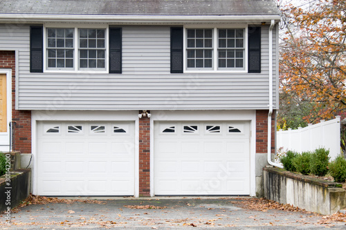 GARAGE DOOR at a traditional single house painted in white color