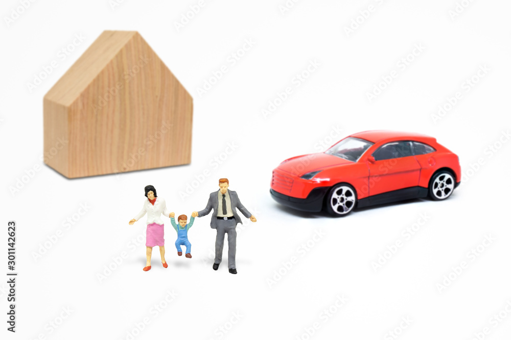 Obraz premium Happy Family Concept : Miniature people as happiness family with wooden house and red car model toy in background.