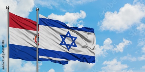 Paraguay and Israel flag waving in the wind against white cloudy blue sky together. Diplomacy concept, international relations.