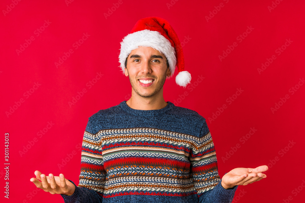 Young man on christmas day crossing fingers for having luck Young man on christmas day crossing fingers for having luck