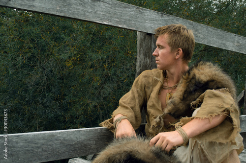 Obraz na plátně Downshifting concept - medieval peasant in a ragged clothes reconstruction