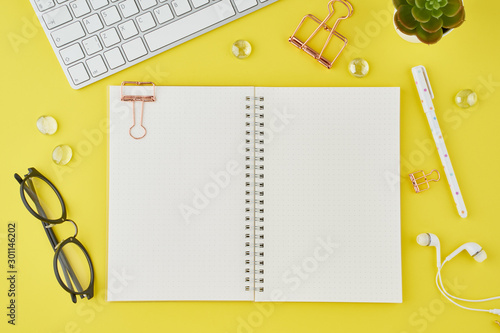 Wallpaper Mural Blank notepad page in bullet journal on bright yellow office desktop. Top view of modern bright table with notebook, stationery. Mock up, copy space, concept for diary Torontodigital.ca