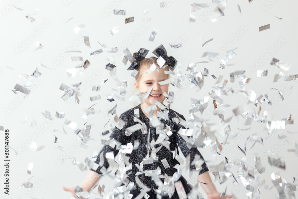 Party, holidays, new year and celebration concept - Female child throwing confetti. Party, holidays, new year and celebration concept - Female child throwing confetti.