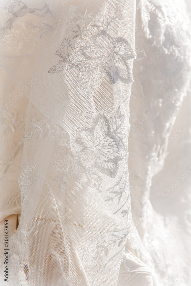 Details of the bride dress fabric and beautiful embroidery wedding concept used as a background for illustrations Details of the bride dress fabric and beautiful embroidery wedding concept used as a background for illustrations