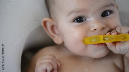 Cute baby with a yellow teething ring. Cute baby portrait