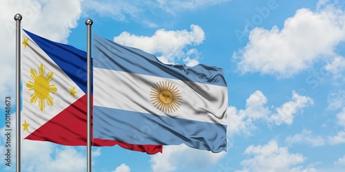 Philippines and Argentina flag waving in the wind against white cloudy blue sky together. Diplomacy concept, international relations.