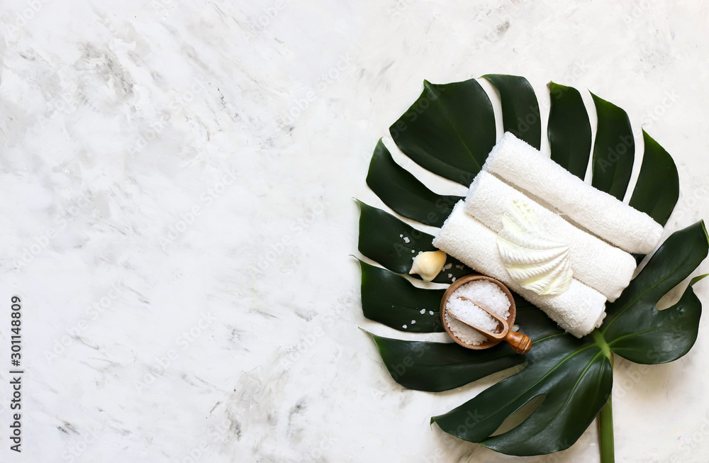 Spa massage products with monstera leaves on marble background - obrazy, fototapety, plakaty 