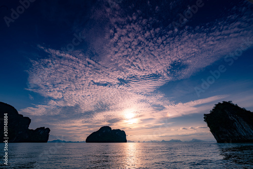 Beautiful scenic seascape at sunset blue sky and clouds with small islands and calm sea in the malacca straits of Krabi Thailand photo