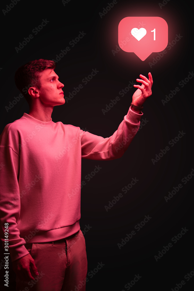 Man holding instagram like icon in hand on black background Stock Photo |  Adobe Stock