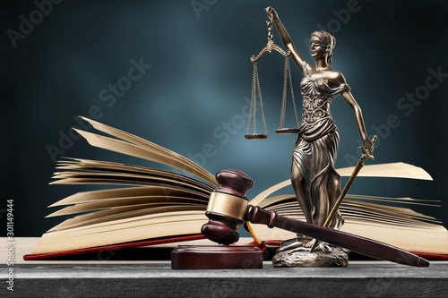 Closeup of a sculpture of Themis, book and gavel, symbol of justice photo