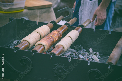 Closeup trdelnic baking process. Traditional food photo