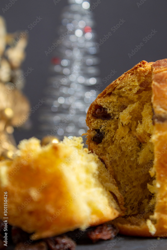Christmas Panettone with slice and preparing ingredients to make panettone with egg, milk, and raisins setting. Typical Italian Christmas holiday cake Christmas Panettone with slice and preparing ingredients to make panettone with egg, milk, and raisins setting. Typical Italian Christmas holiday cake