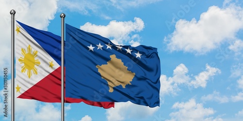Philippines and Kosovo flag waving in the wind against white cloudy blue sky together. Diplomacy concept, international relations.