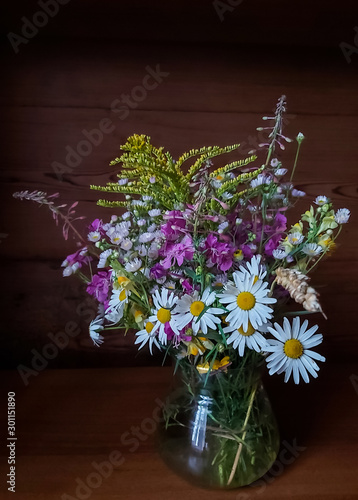 Wallpaper Mural beautiful bouquet of bright wild flowers on a wooden background in a glass vase Torontodigital.ca