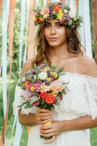 Beautiful bride holding wed...