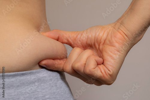 Obesity, excess weight close up