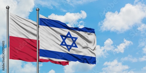 Poland and Israel flag waving in the wind against white cloudy blue sky together. Diplomacy concept, international relations.