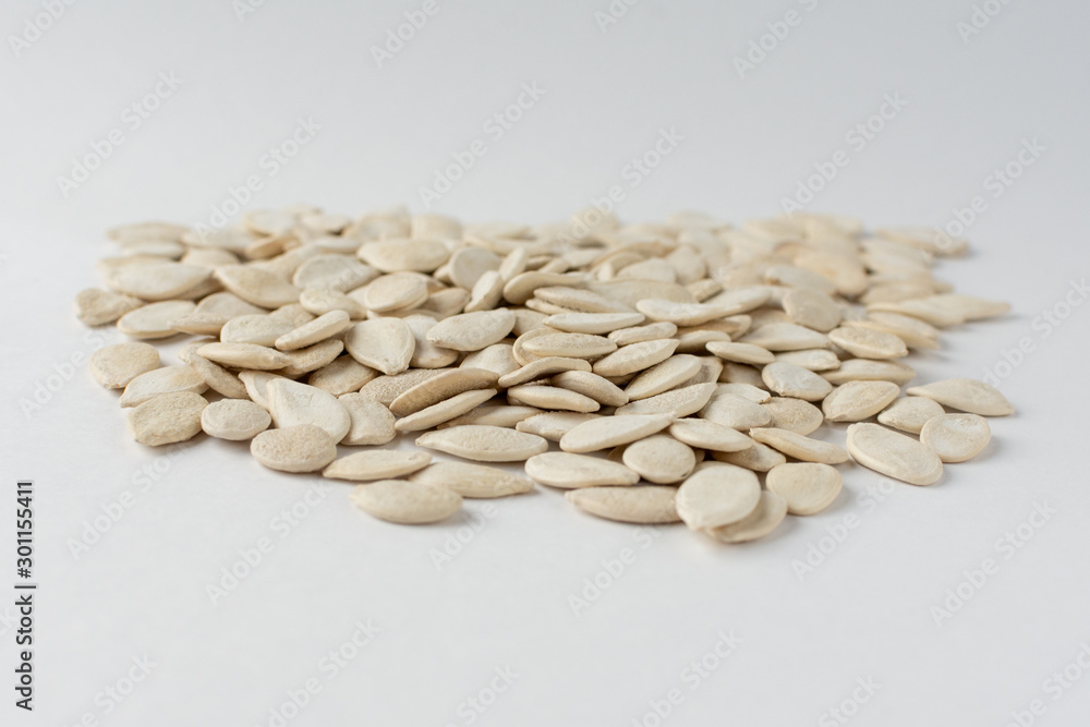 Roasted pumpkin seeds with salt on white background. Roasted pumpkin seeds with salt on white background.