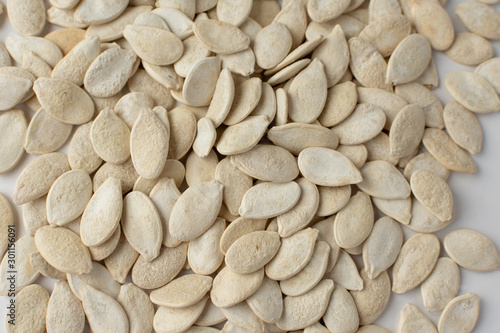 Obraz na plátně Roasted pumpkin seeds with salt on white background.