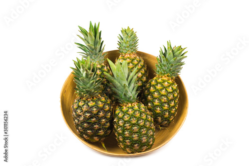 Pineapple in a bowl isolated om white.