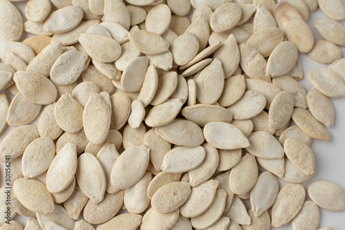 Obraz na plátně Roasted pumpkin seeds with salt on white background.