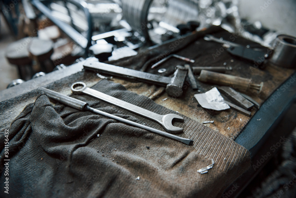 Fototapeta premium Place of work. Tools on dirty table. In garage. Manufactory conception